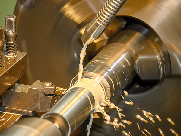 The lathe machine finish cut metal shaft parts with liquid coolant method.