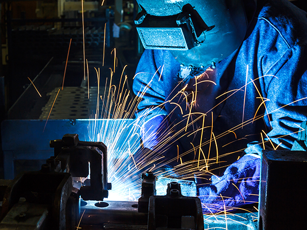 Industrial Worker at the factory welding